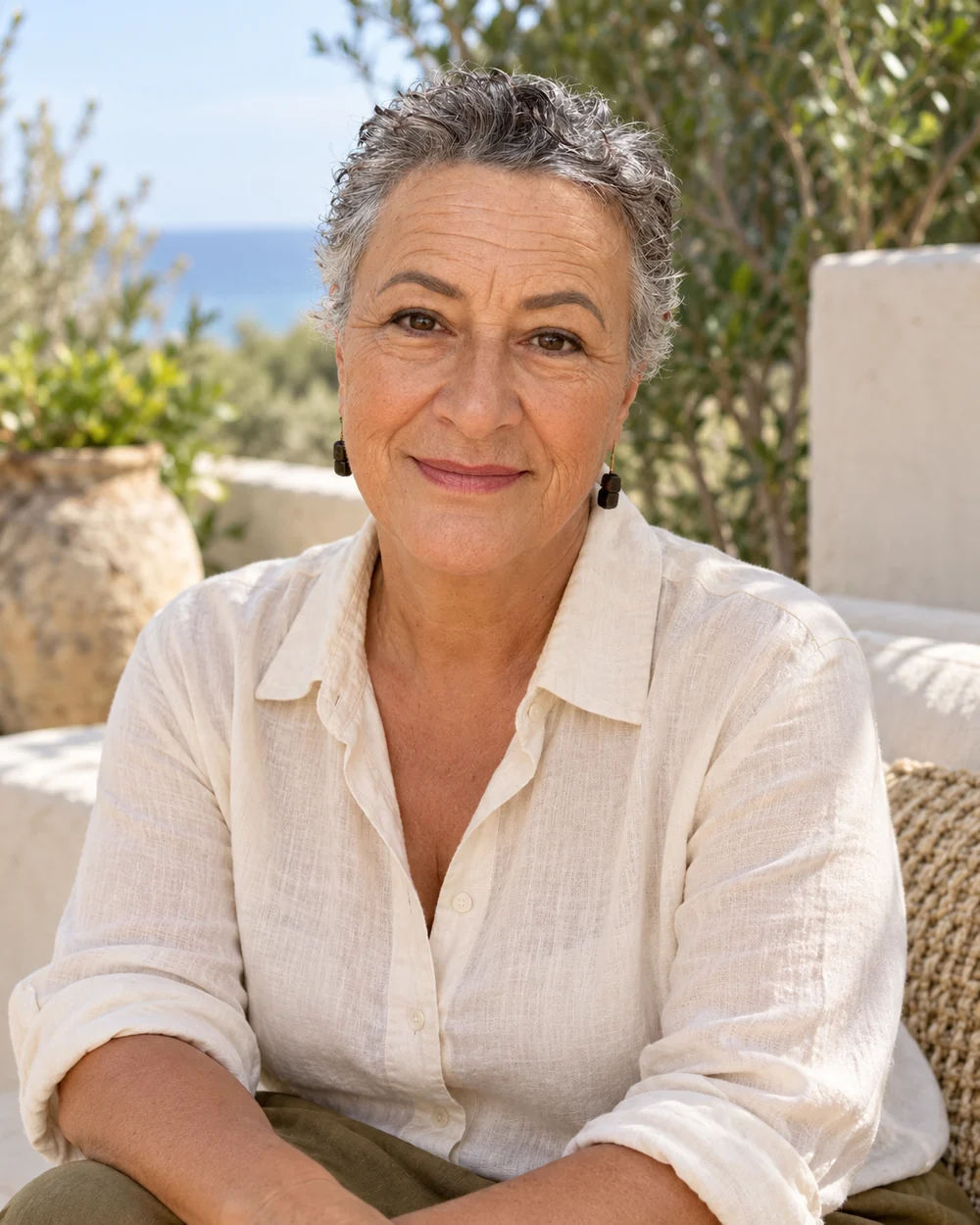 Robyn Haaker with a natural smile, wearing a cream linen shirt
